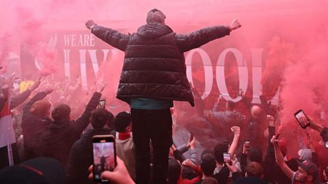 Liverpool bus arrives amid red flare smoke