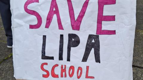 A large banner saying Save LIPA School