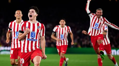 Atletico Madrid players celebrate scoring at Barcelona 