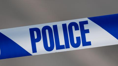 A close up of police tape that reads "police"