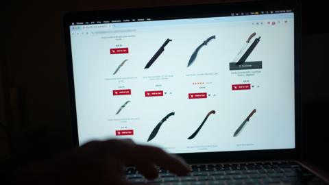 Unseen person purchasing ninja sword online