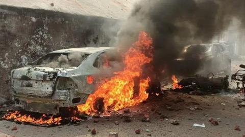 A car set on fire during protests that broke out in Sambhal on Sunday