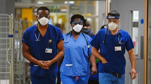 File photo dated 21/12/21 of medical staff wearing FFP3 face masks at King's College Hospital, in south east London.