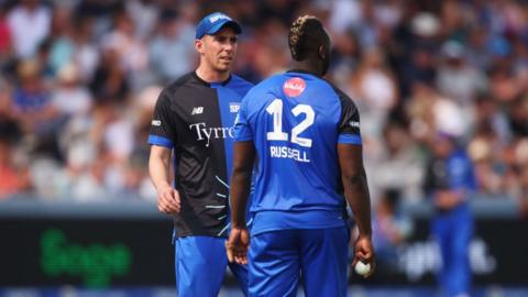 Dan Lawrence interacts with teammate Andre Russel