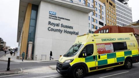 An ambulance drives past the Royal Sussex County Hospital in Brighton.