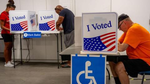 People vote on the first day of Virginia's in-person early voting at Long Bridge Park Aquatics and Fitness Center in Arlington