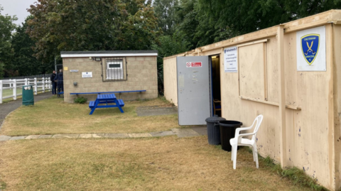 A toilet block and a rudimentary changing pavilion at Cheltenham Saracens Football Club