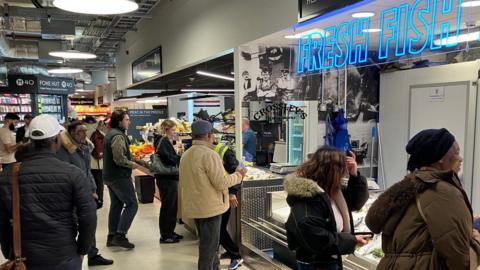 Shoppers at a fish stall at the recently opened Market Hall in Oldham town centre.