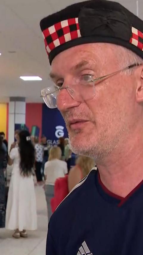 Man wearing glasses and Scotland hat at Glasgow Airport