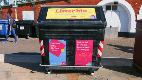 A bin with Brighton and Hove City Council branding on it.
