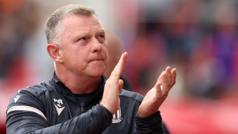 Stoke boss Mark Robins applauding the fans