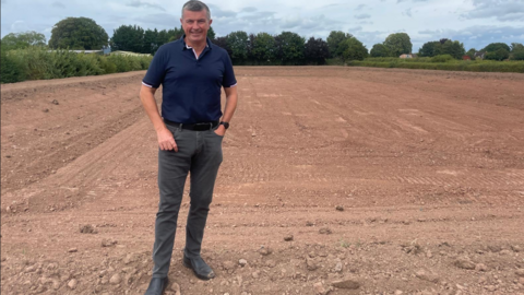 Tim Fawbert from Wyevale Nursery stood in a field where the new reservoir will be built