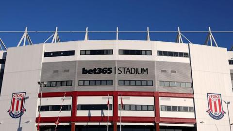 Outside view of the bet365 Stadium showing name either side of giant club crests