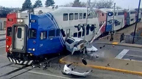 Car smashed into pieces as train collides with it