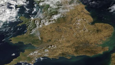 A satellite image shows the south of England looking brown after the impact of drought