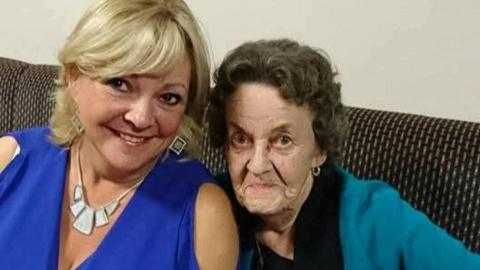 Karen Westgarth pictured with her mum. They are both smiling. Mrs Westgarth has blonde hair and wears a blue top and silver jewellery. Her mum has short dark hair and wears a blue cardigan.