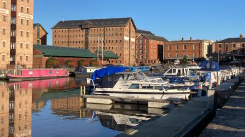 A shot of Gloucester Docks with pleasure boats and Victorian warehouses in the background
