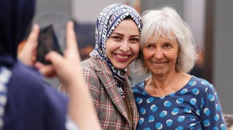 An Afghan student with Linda Norgrove's mum, Lorna