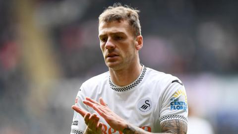 Josh Tymon applauds after a Swansea game