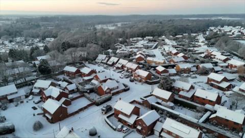 Aerial shots of a snow-covered housing estate in Norfolk
