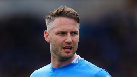 A close up of Stockport County midfielder Nick Powell during a match