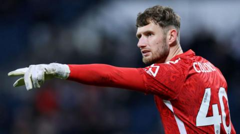 Coventry City goalkeeper Brad Collins points during a match.