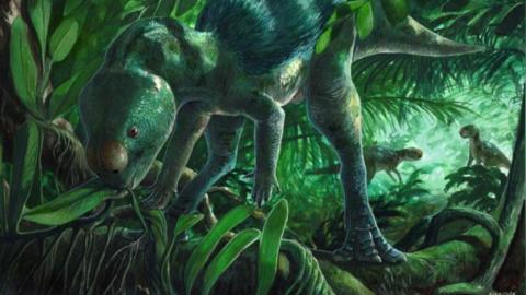 A sketch of a small green dinosaur stood on two legs in a forest as it leans forwards to eat a leaf
