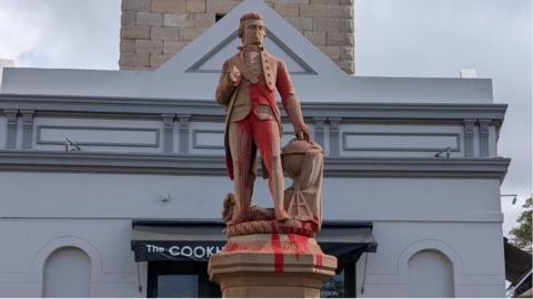 Red paint covers a statue of Captain Cook in Sydney