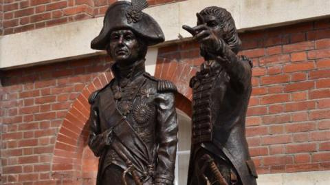 Bronze statue of Lord Nelson (left) and Sir George Murray pointing outside Murray's former home in North Street in Chichester