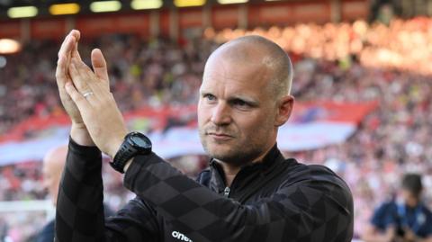 Liam Manning applauding at the end of a Bristol City match