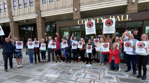 Campaigners outside County Hall following the announcement