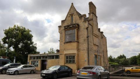 The Old Station in Cirencester with cars parked outside