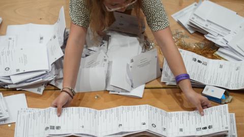 Ballot papers are sorted and verified for the Clacton by-election at Clacton Leisure Centre