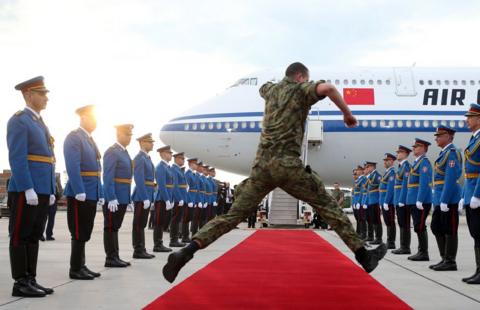 A serviceman jumps over the red carpet as honour guards prepare for the departure of the Chinese President Xi Jinping in Belgrade, Serbia, 08 May 2024. 