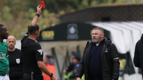 Wayne Rooney is shown a red card by referee James Linington