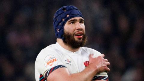 England's George Martin clutches his injured shoulder