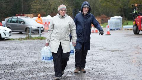 People collect bottled water from the Upper Pantiles car park in Tunbridge Wells