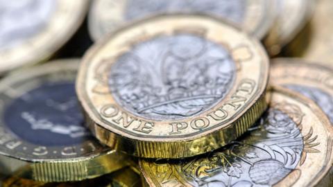 A stock image of a pile of pound coins. 