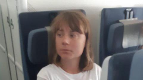 Israeli foreign ministry handout photo showing Swedish campaigner Greta Thunberg on board a plane from Israel to France (10 June 2025)