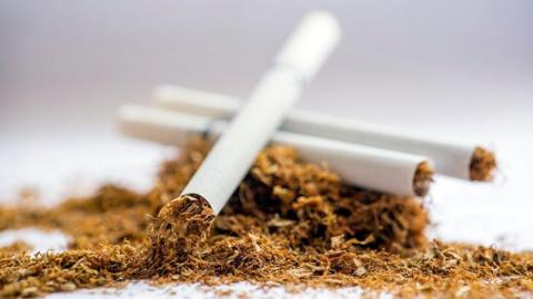 Stock image of a cigarette on tobacco