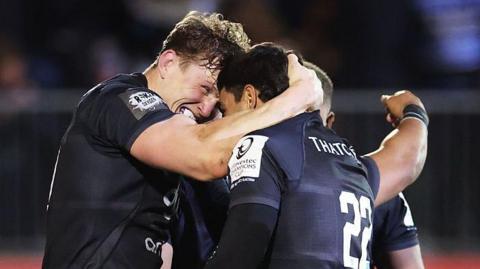 Ted Hill celebrates his match-winning try with his Bath team-mates