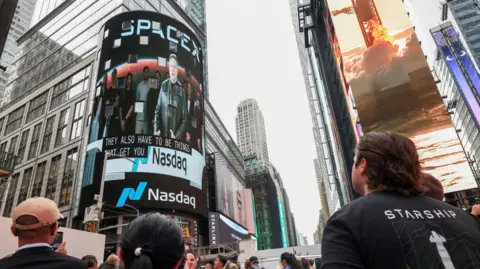 SpaceX founder and CEO Elon Musk is shown on a screen making a speech before his company is listed on the Nasdaq market in New York, New York, USA, 12 June 202