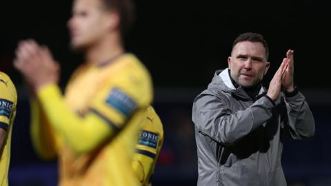 John Eustace walks off the pitch with his Derby County players