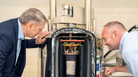 Dr Jason Jones and Professor Richard Telford looking closely at an NMR machine