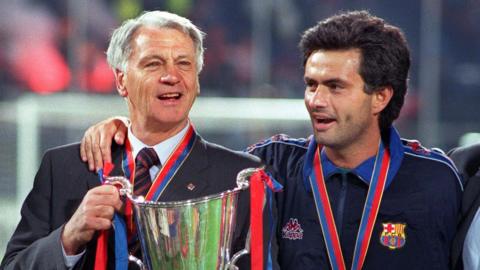 Jose Mourinho embraces Bobby Robson as they hold a trophy
