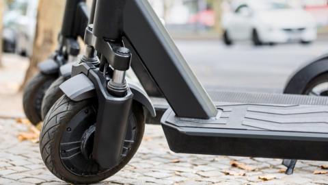 Close up of black e scooter in front of road