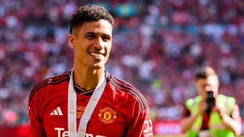 A smiling Raphael Varane at Wembley wearing his FA Cup winner's medal