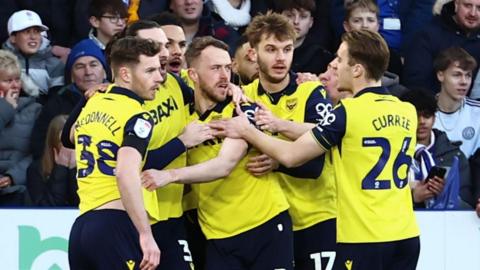 Oxford players celebrate scoring against Leicester City