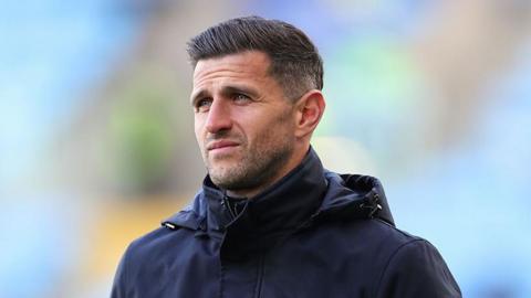 John Mousinho looks on from the sidelines