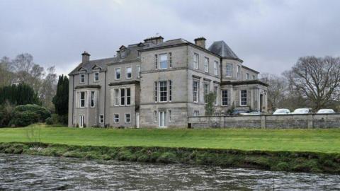 Kingsmeadows House, a stately-looking home, sitting on the banks of the river Tweed, surrounded by woodland
